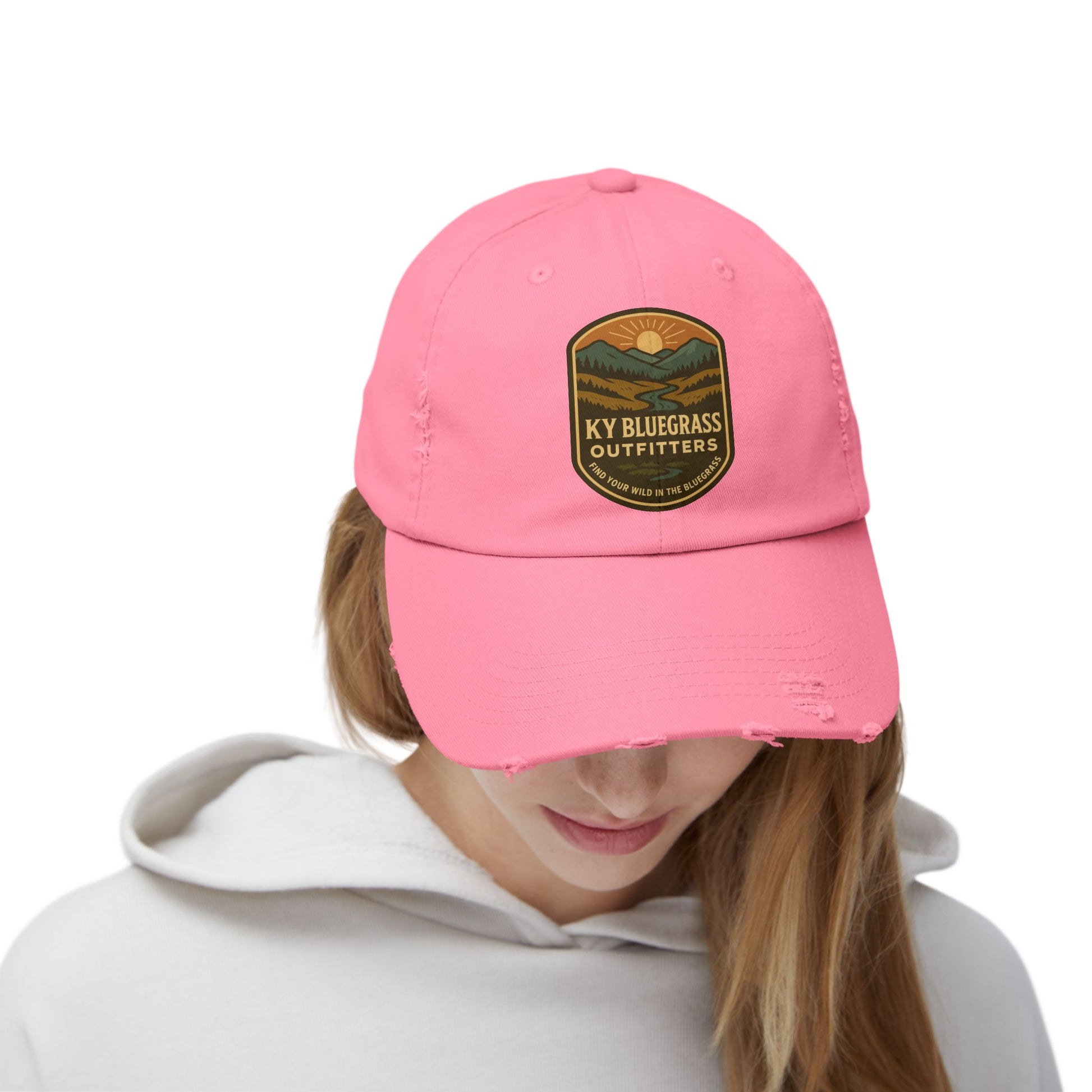 Pink cap with a logo worn by a person on a white background