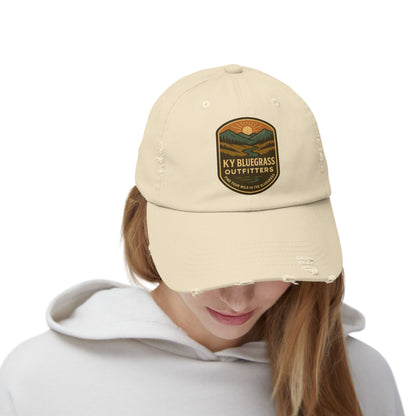 Beige cap with 'KY Bluegrass Outfitters' logo worn by a person on a white background