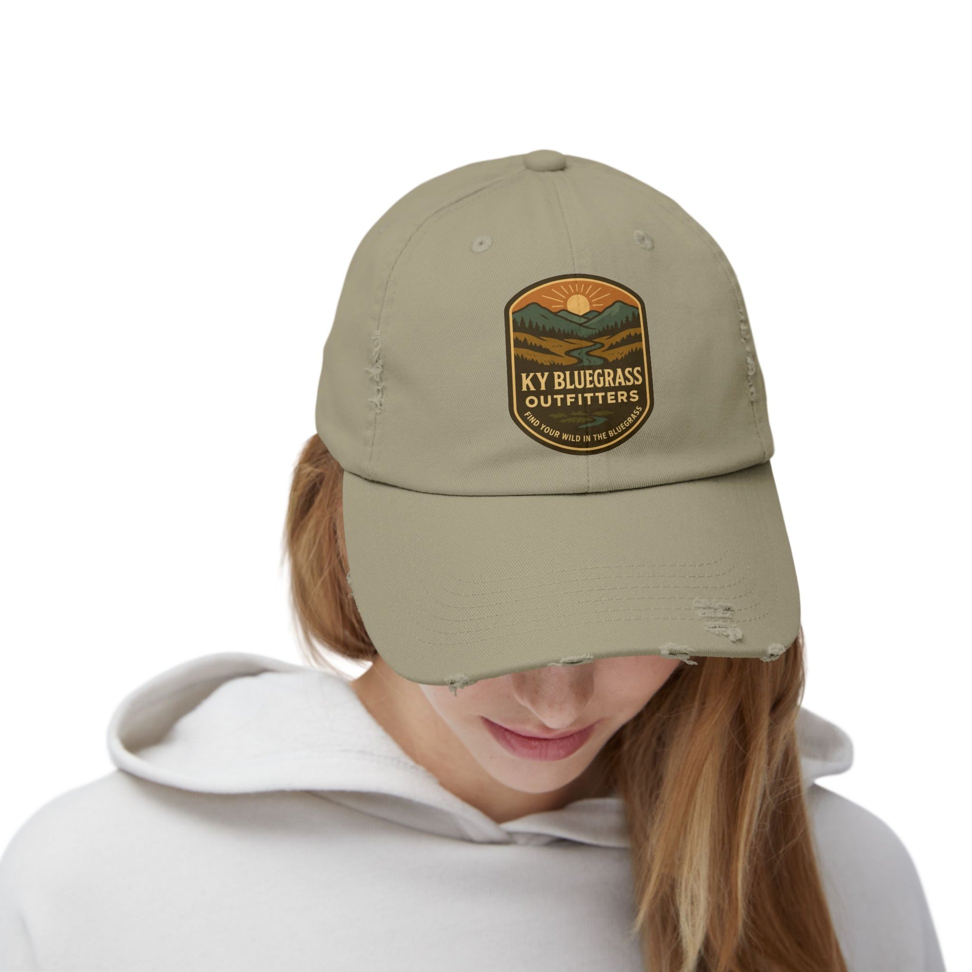 Person wearing a beige cap with a logo on a white background