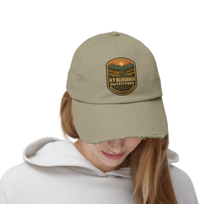 Person wearing a beige cap with a logo on a white background